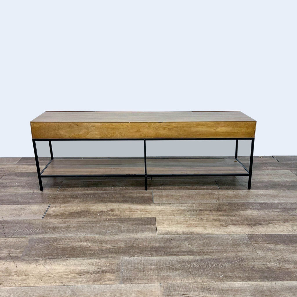 Back view of a wooden credenza with metal support and shelf underneath.  
