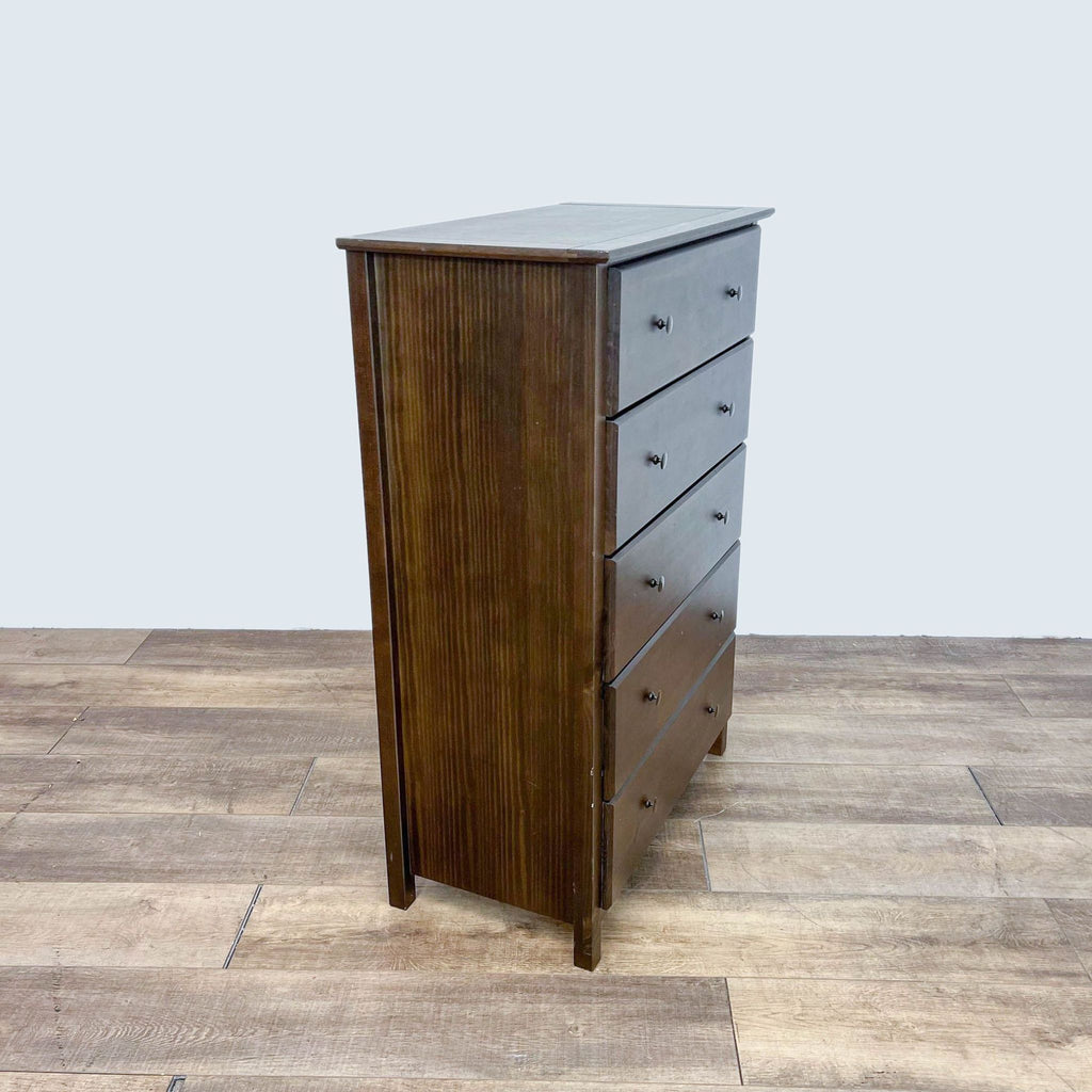 Solid pine dresser with a cherry finish, featuring five drawers with metal knobs and glides.