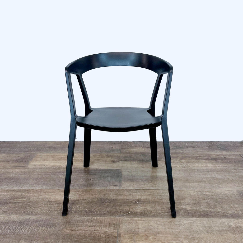 Front view of black Compas Armchair on hardwood floor by Rove Concepts.