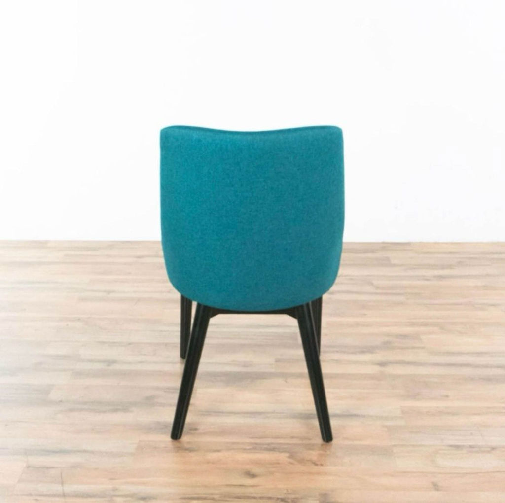 Rear view of teal Viscount chair, highlighting upholstery and leg design.