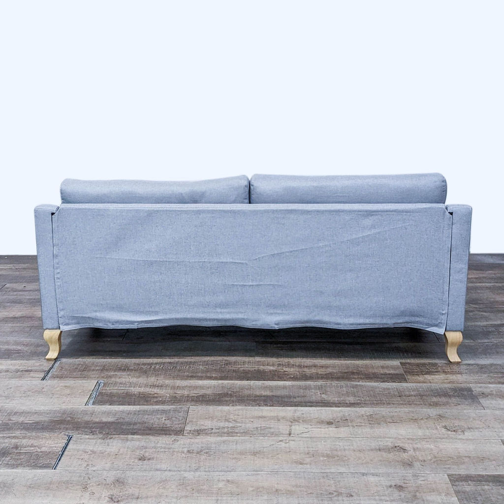 Rear view of a gray Reperch 3-seater sofa with cabriolet legs.