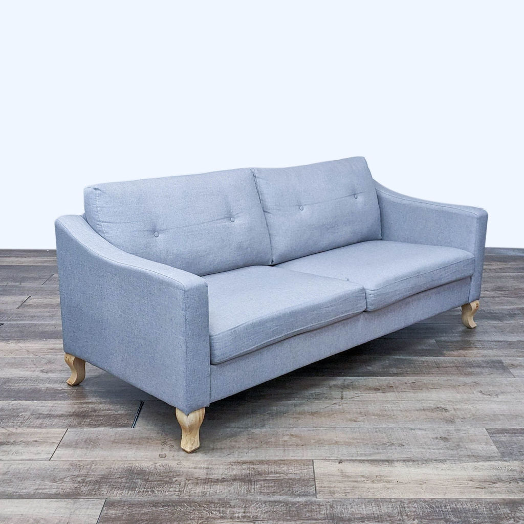 Side view of a Reperch 3-seater gray fabric sofa with light finish feet.