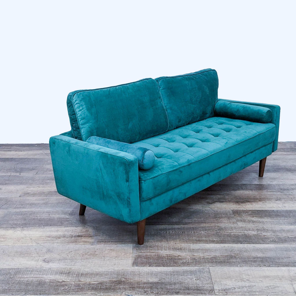 Side view of a teal 3-seat sofa with tufted seat and sleek design.