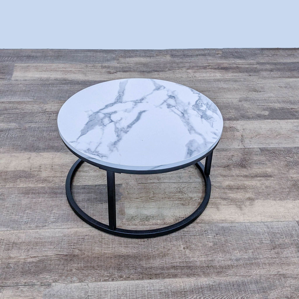 Small round table with a faux marble top and metal base from Reperch.