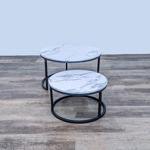 Round coffee tables with faux marble tops and black metal frames by Reperch.