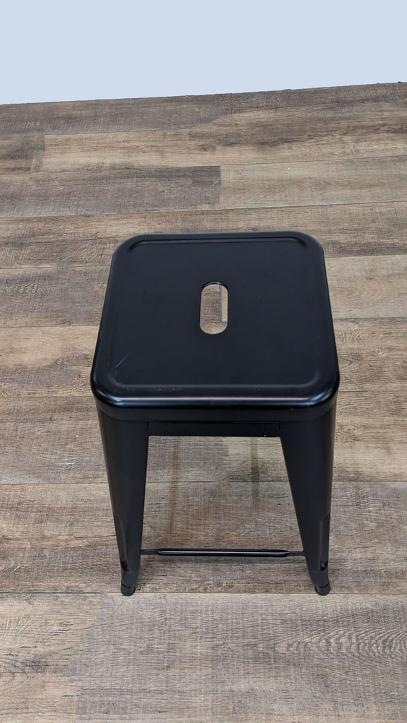 Top view of a black metal counter stool with sleek design.