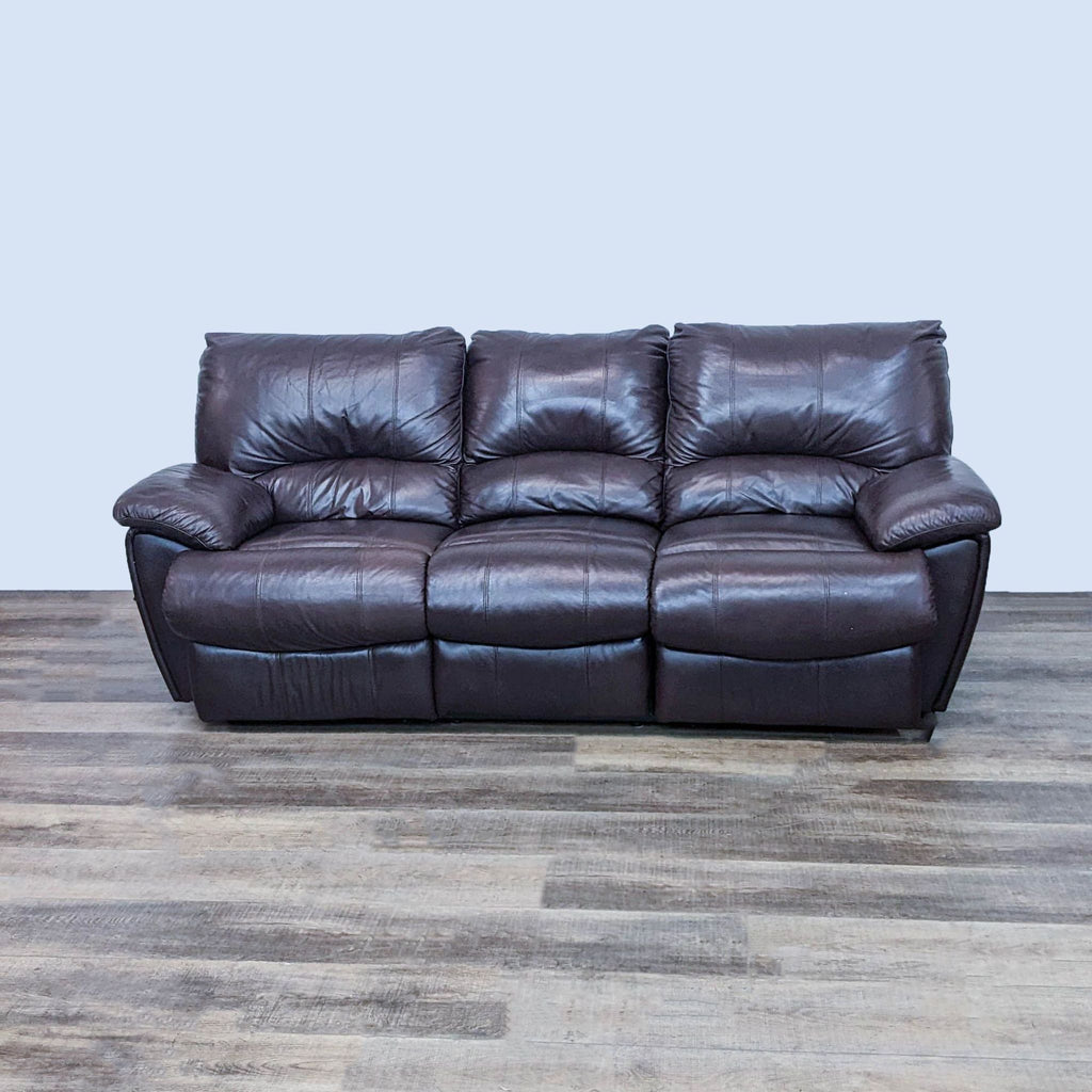 Reclining brown leather-look sofa, 3-seat with plush arms for comfort.