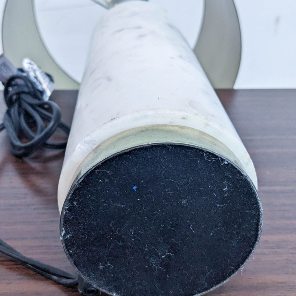 Close-up of the lamp's base, showcasing the marble texture and attached power cord.