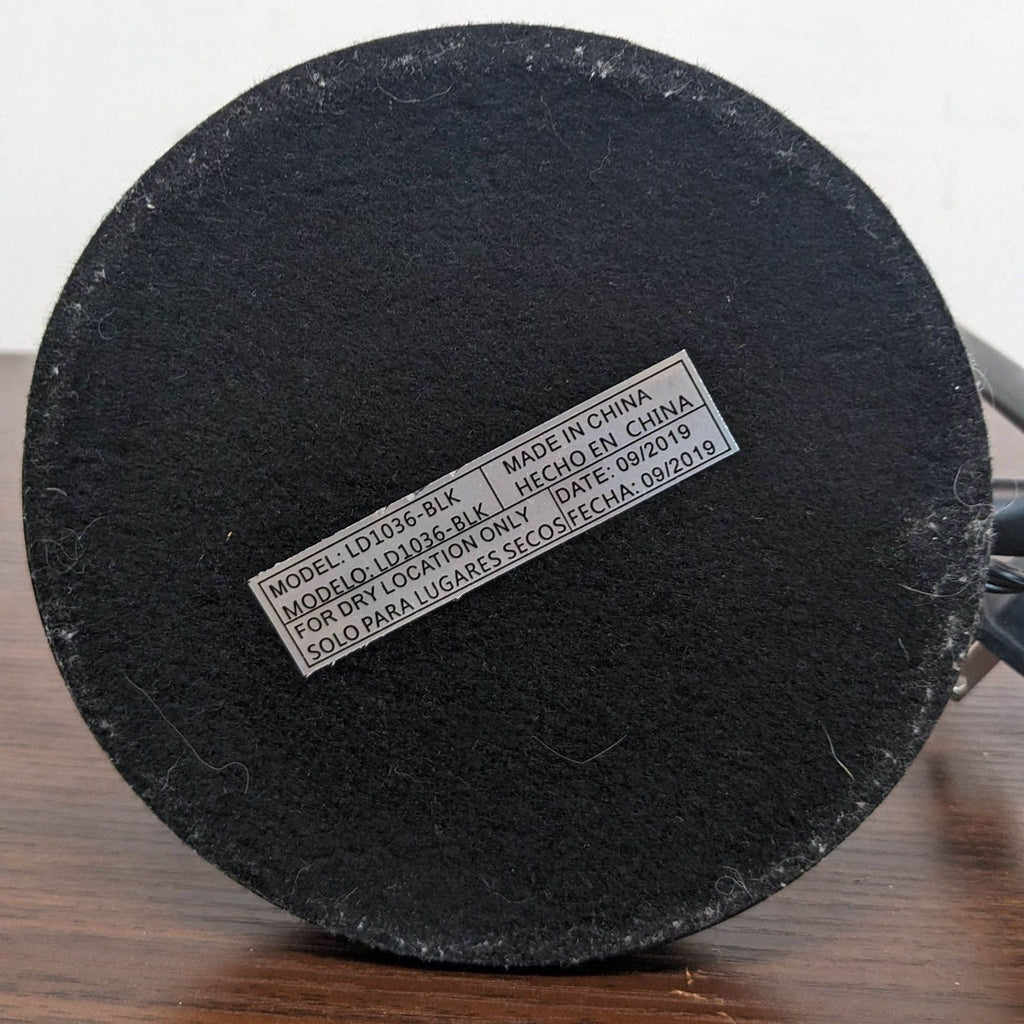 Close-up of the Reperch lamp's base label, listing model LD1036-BLK and manufacturing details.