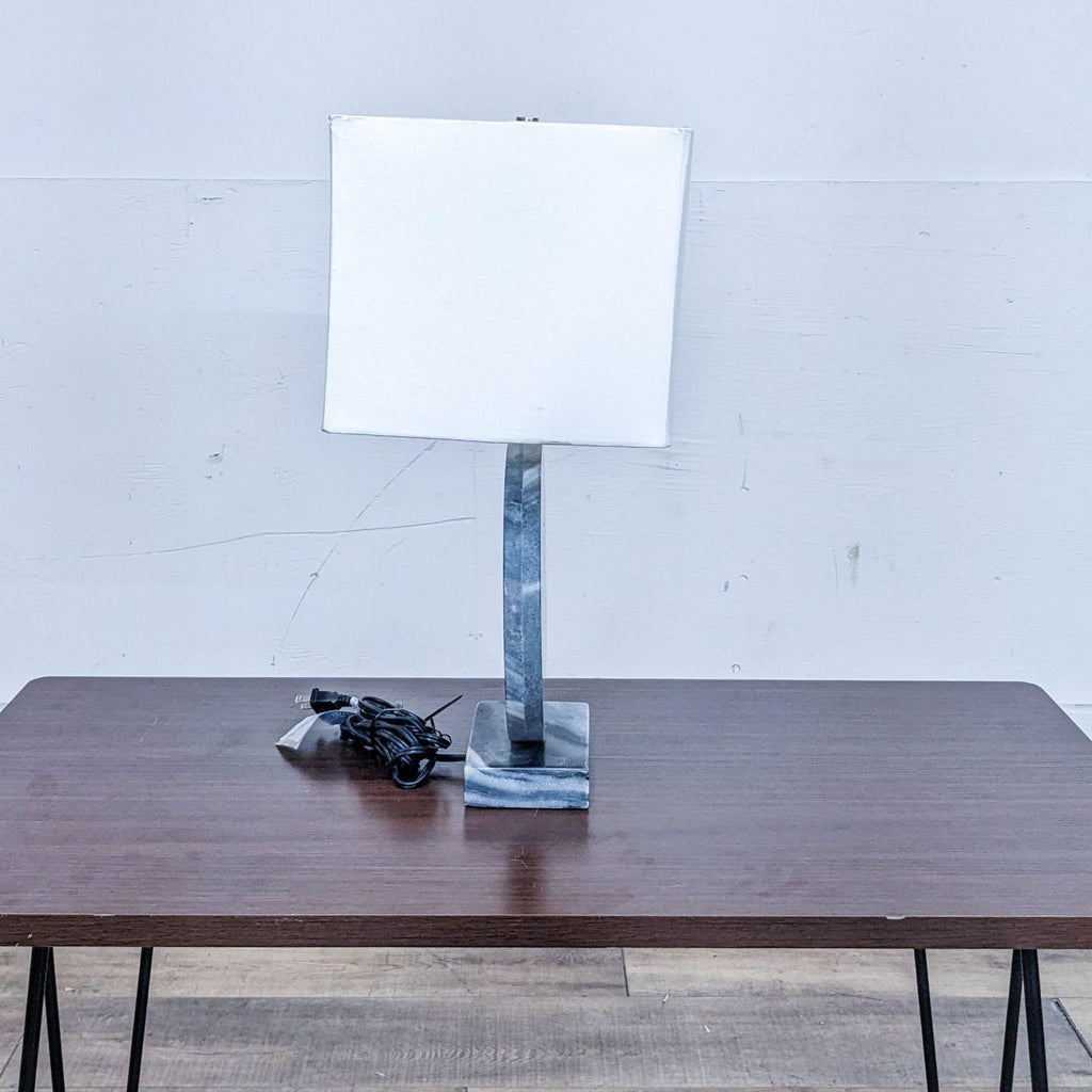 Reperch lamp with rectangular white shade and blue stone base seen from the side.
