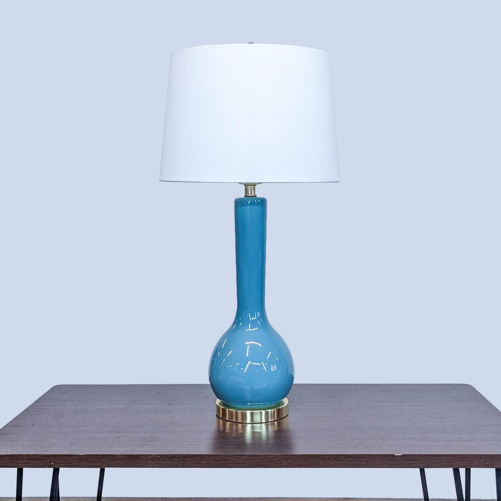Elegant Safavieh lamp featuring a blue ceramic body and white shade.