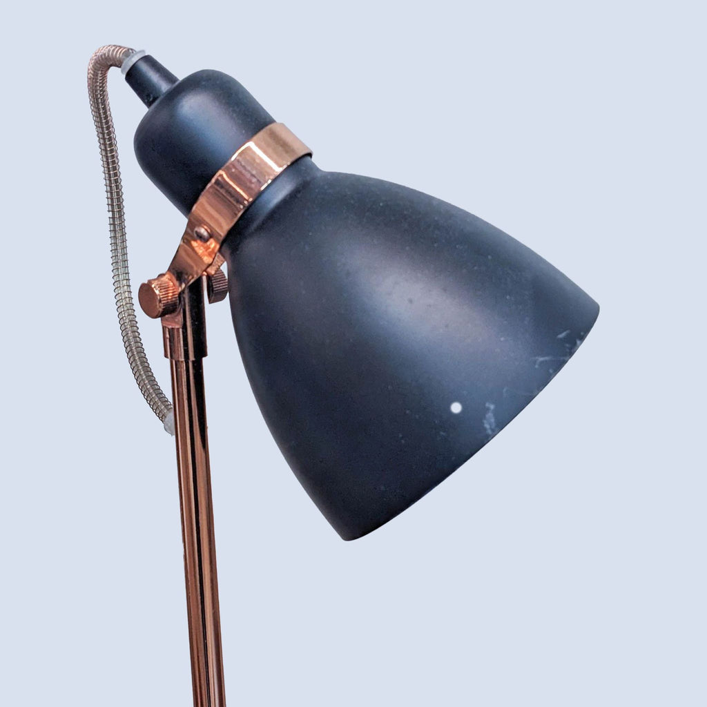 Close-up of a black Reperch lamp head with copper accents.