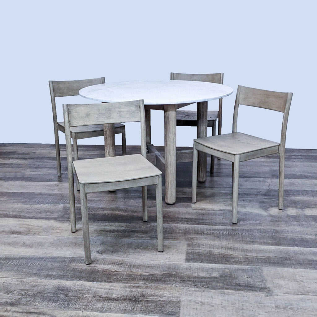 West Elm 5-piece dining set with marble table and four Dune-finished chairs.
