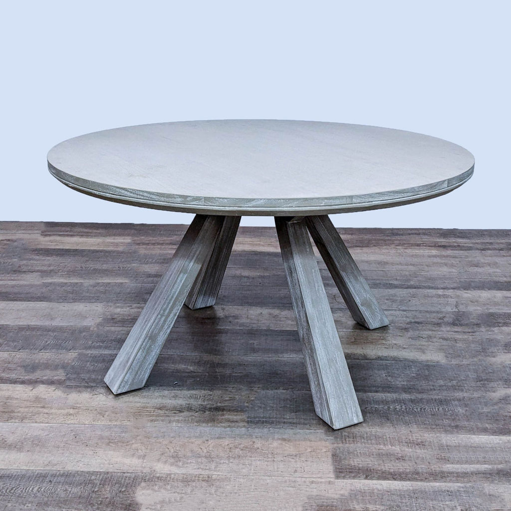 Zuo Modern Beaumont dining table, round and coastal style, with flared legs in a light wood finish.