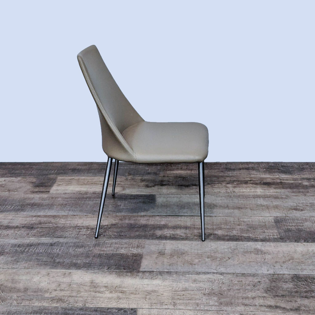 Side view of Whisp dining chair, featuring slim wing back and supportive chrome legs.
