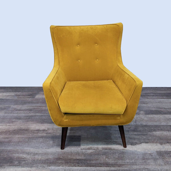 Front view of a mid-century modern chair with yellow velvet and button tufting.