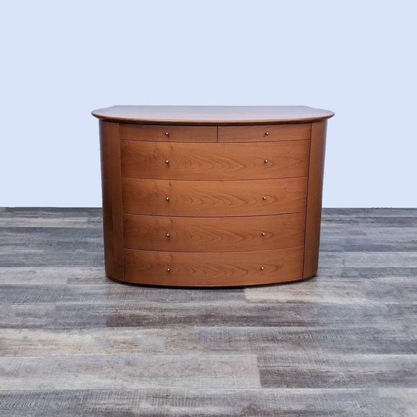 Contemporary cherry wood dresser with curved front and six drawers.