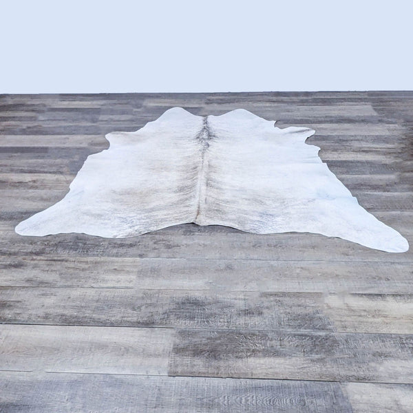 Room & Board Brindle steer hide rug on wood floor, made in Brazil.
