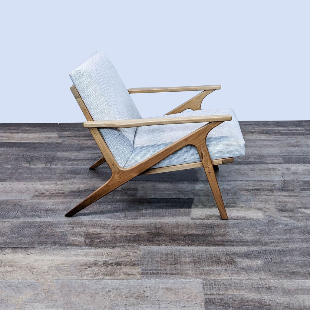 Side view of the mid-century style Cavett chair by Crate & Barrel with angled wooden arms.