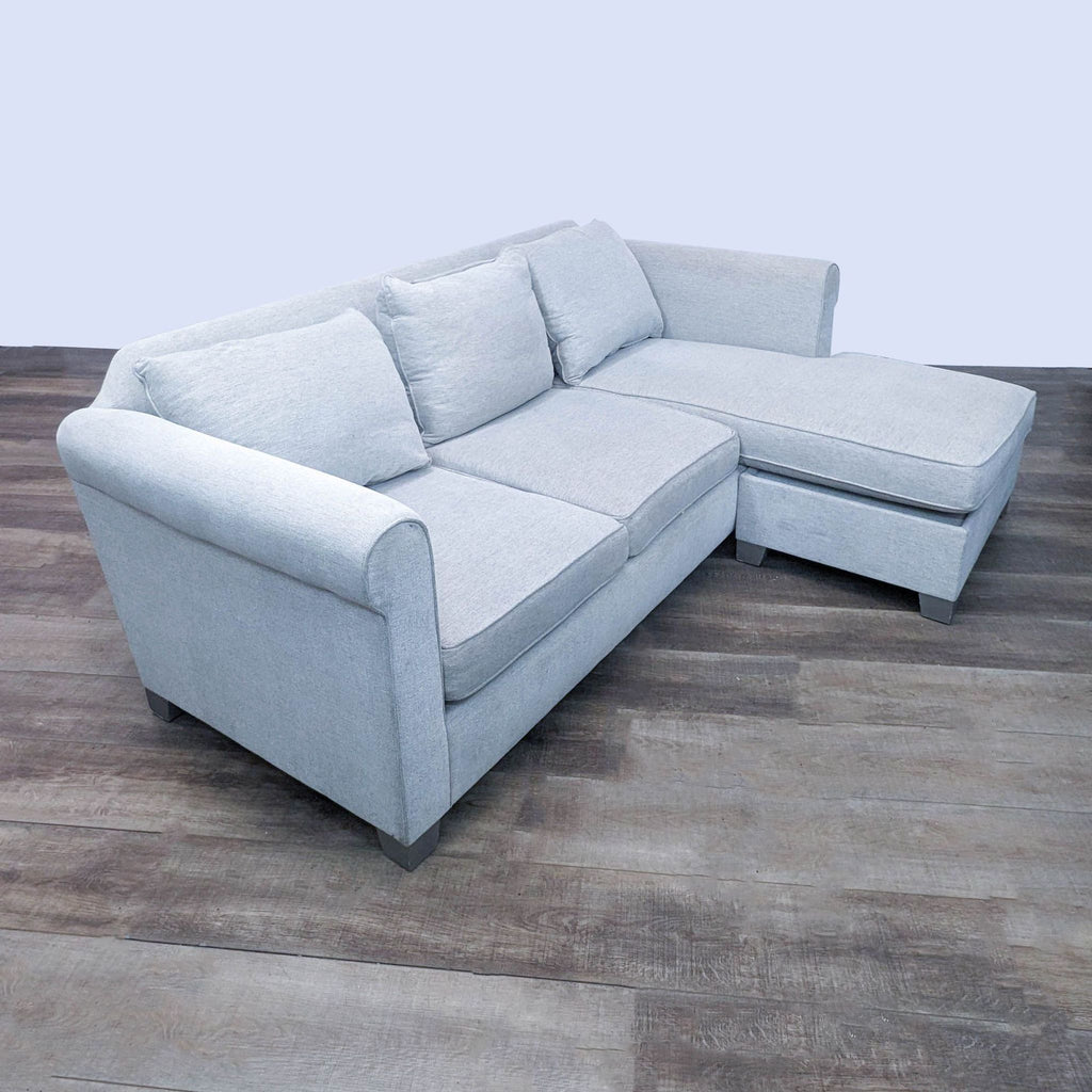 Off white sectional sofa with rounded arms and reversible chaise.  