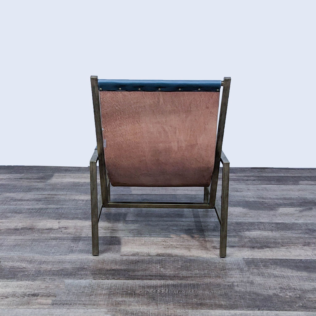 Back view of the Wright sling chair, highlighting the leather sling-style seat and sturdy metal frame.