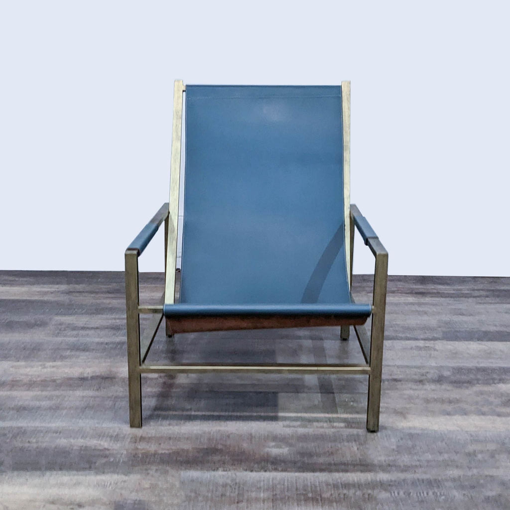 Front view of the Wright sling chair, featuring a sleek metal frame with a blue leather seat.