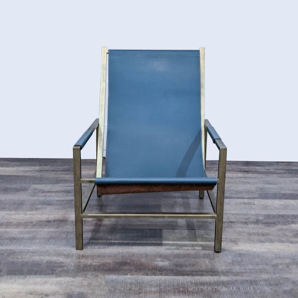 Front view of the Wright sling chair, featuring a sleek metal frame with a blue leather seat.
