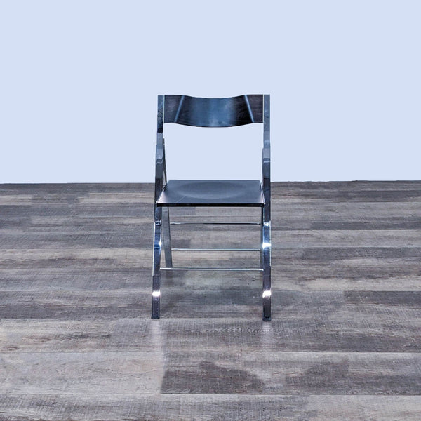 1. Front view of a Resource Furniture Pocket dining chair with a chrome foldable frame and black wood seat.