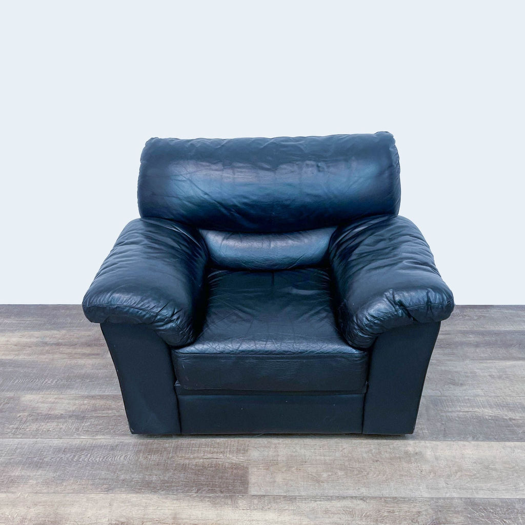 Transitional black leather lounge chair with plush armrests.