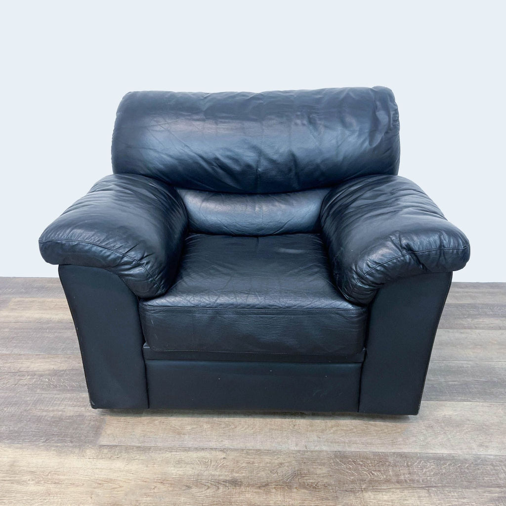 Black leather lounge chair, Reperch brand, comfortable design.