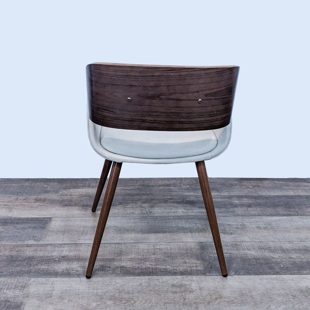 Back view of the Cyprus dining chair showcasing its walnut-finished bent-wood frame and legs.