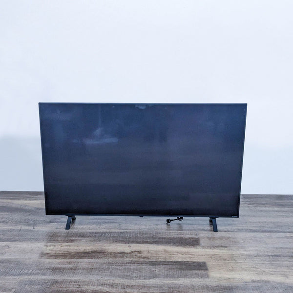 LG TV with a blank screen on a wooden table.