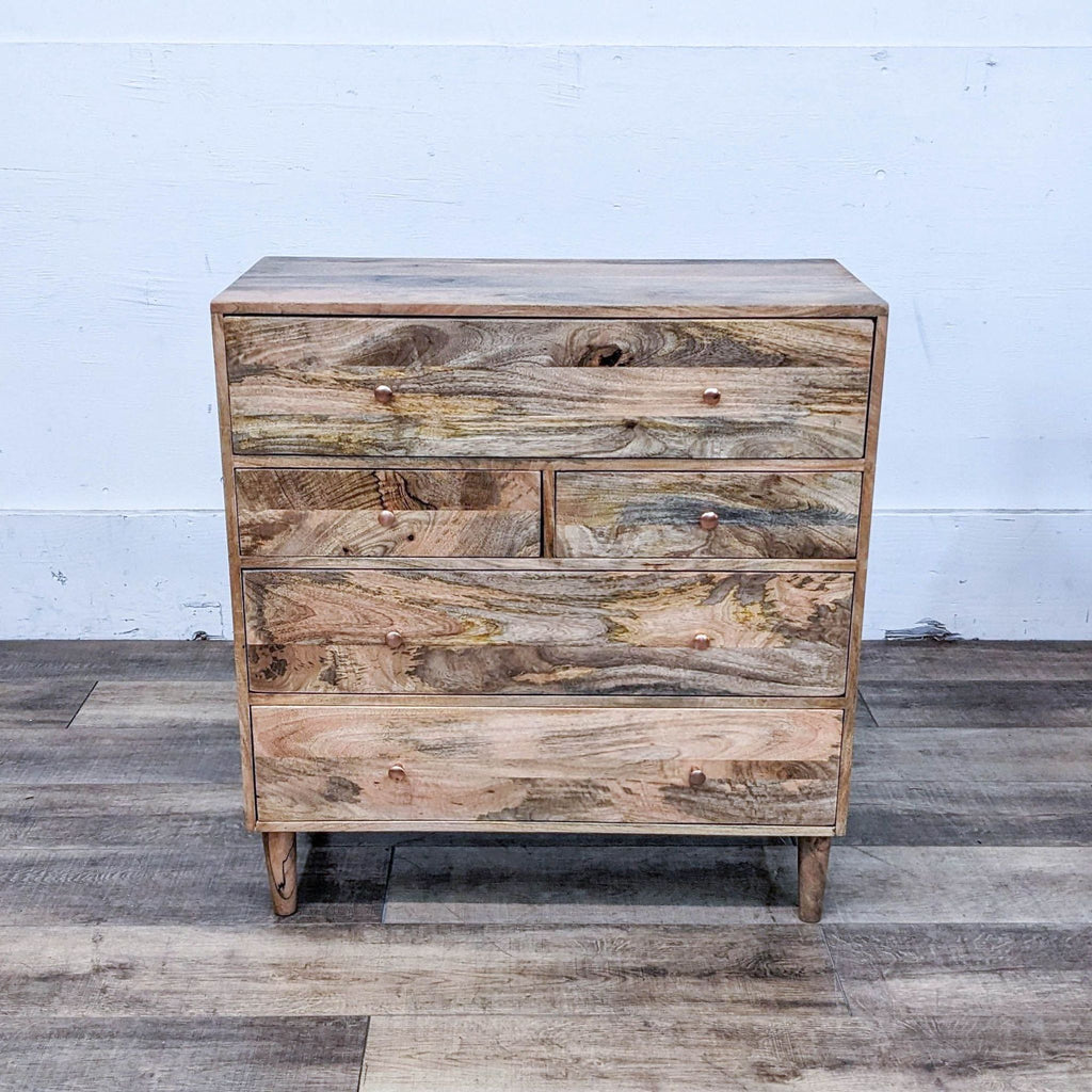 Front view of Reagan dresser by Urban Outfitters, featuring natural mango wood and five drawers.