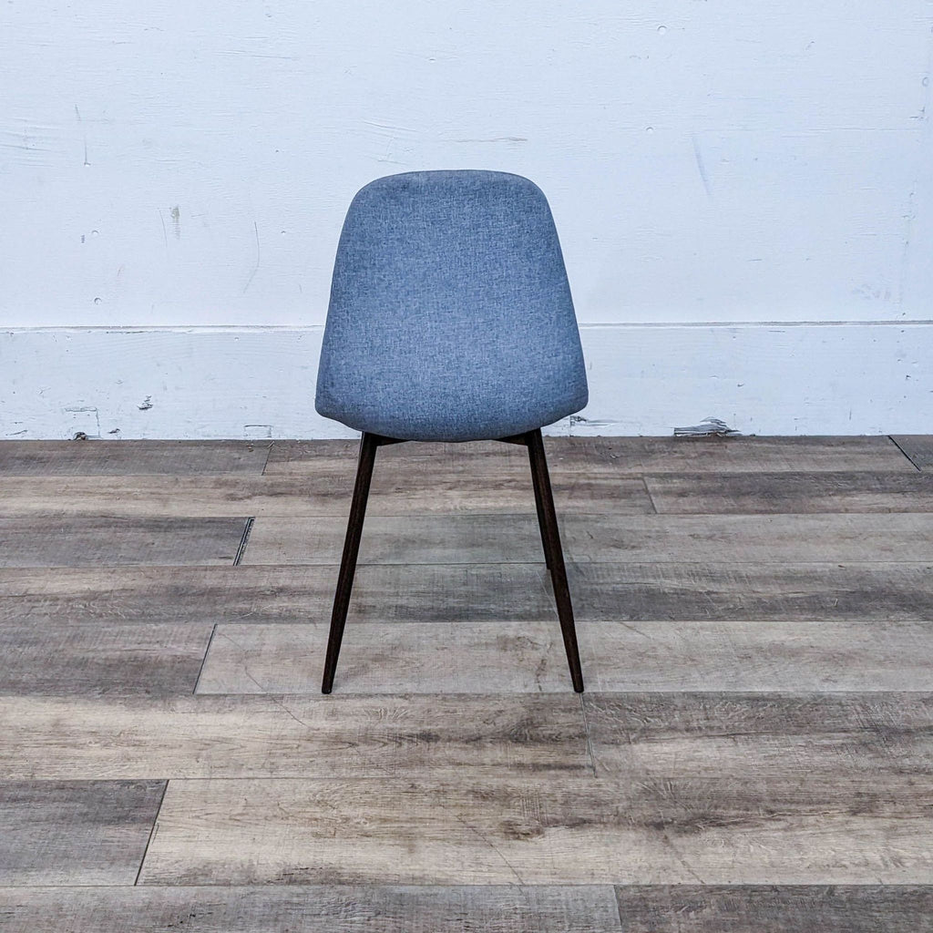 Modern dining chair featuring a curved seat and sleek metal legs.