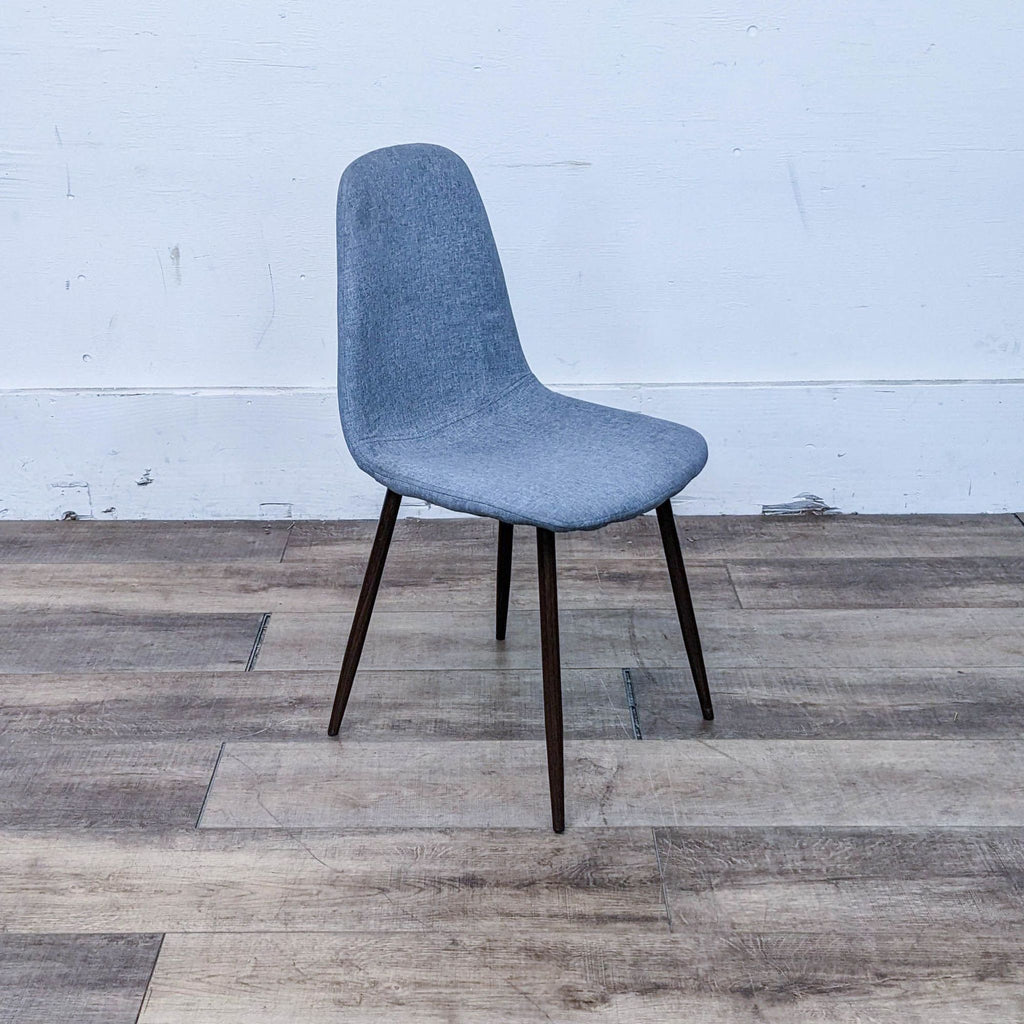 Reperch dining chair with fabric upholstery and walnut-finished legs.
