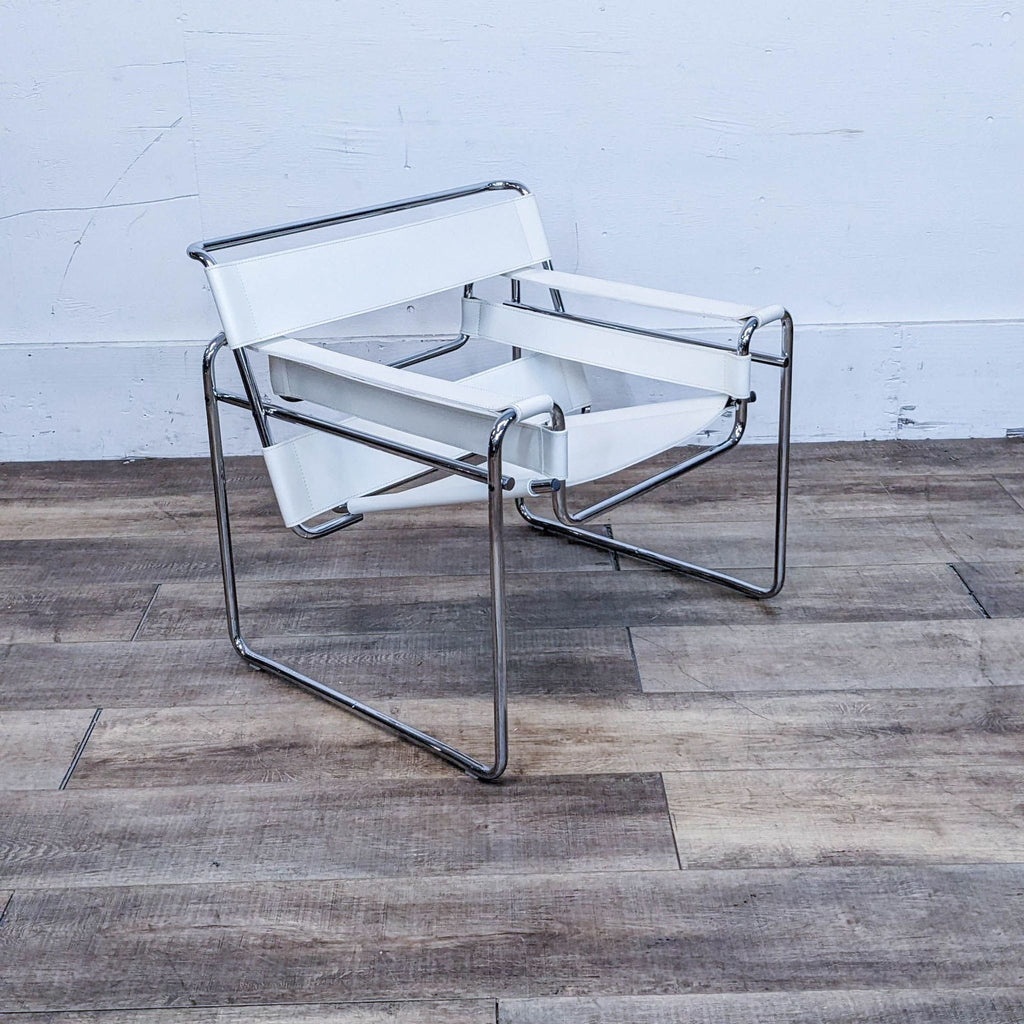 Modern chair with a chrome-finished tubular steel frame and white leather seating, on a wooden floor.
