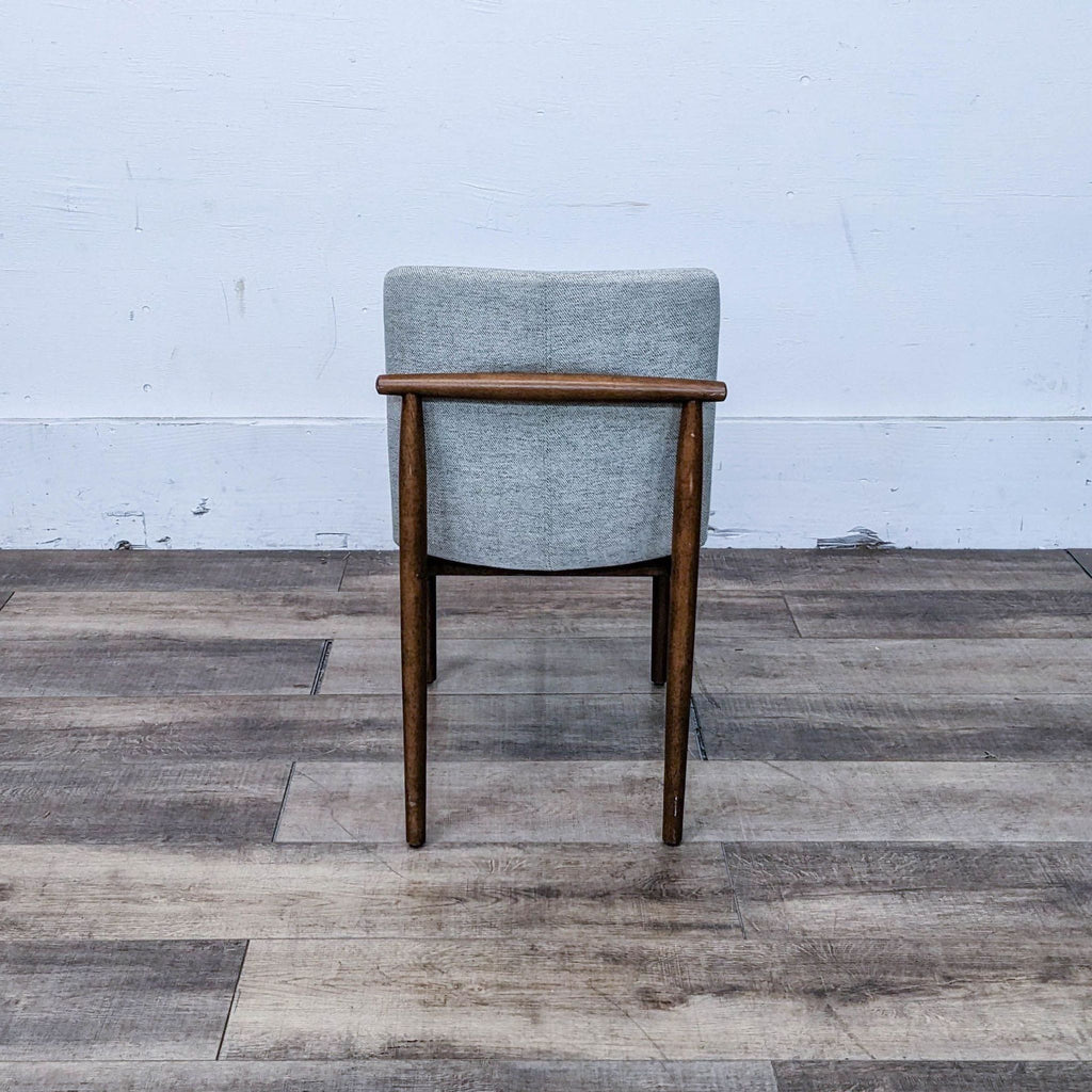 Back view of the Framework Dining Chair showcasing walnut finish and upholstered back from West Elm.