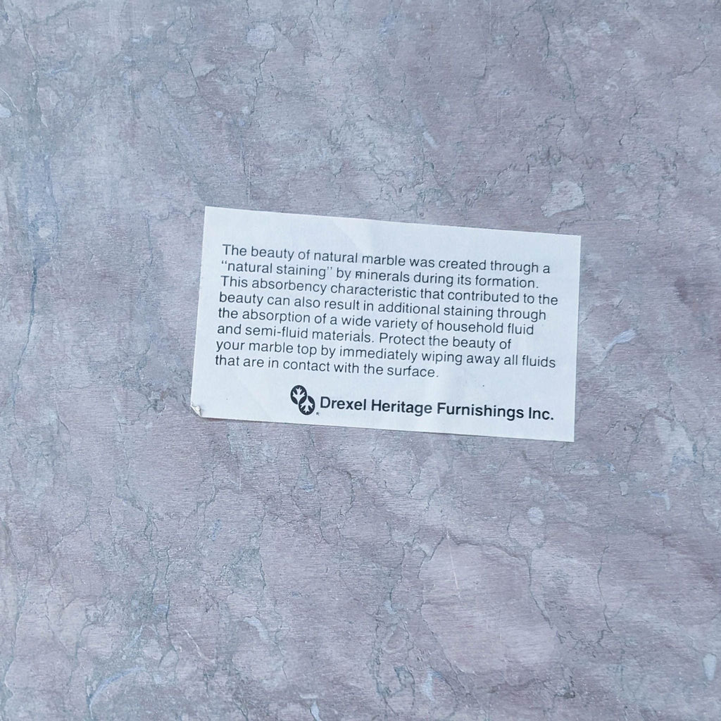 Close-up of Drexel Heritage note about marble's natural staining and care instructions.