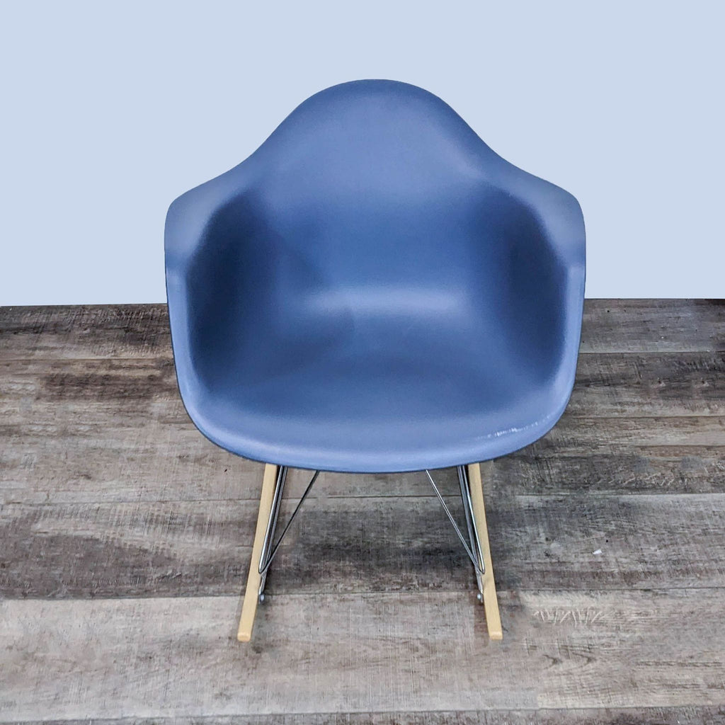 Modern bucket seat rocker with chrome steel base and wooden rockers.