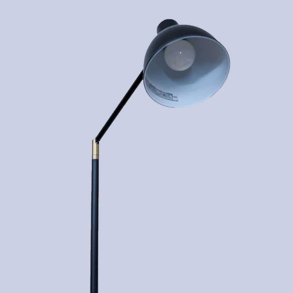 2. Close-up of black lamp head with adjustable arm by Reperch.