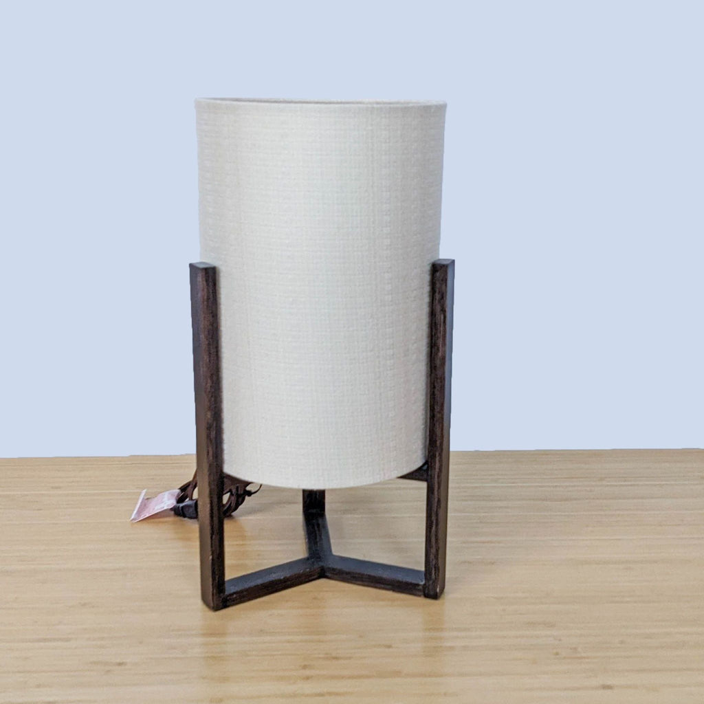 Reperch brand table lamp with cream shade and dark brown metal base on wooden surface.
