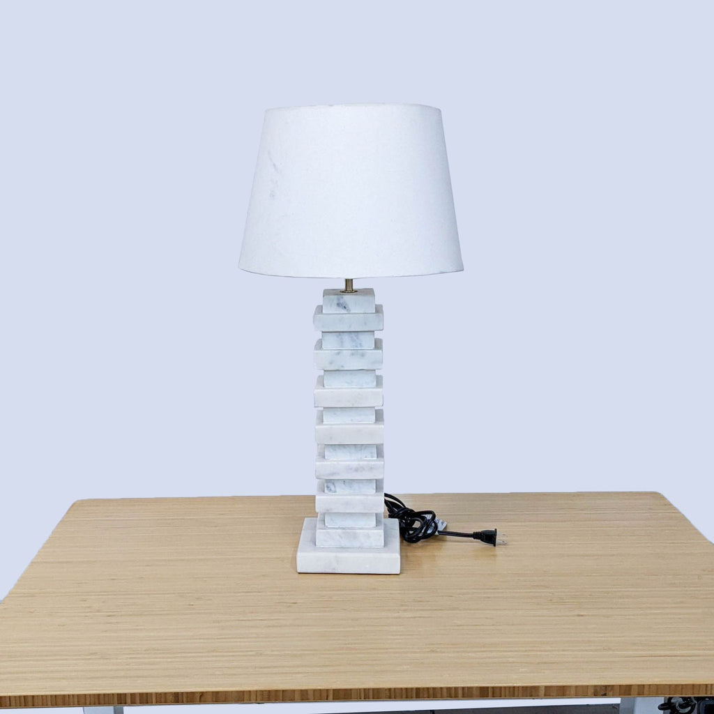 Full view of Reperch marble lamp and shade on a wooden surface, cord visible.