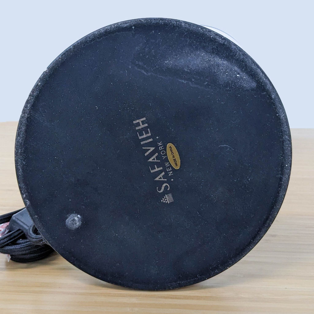 Close-up of Safavieh lamp base showing brand name and power cord on the table.