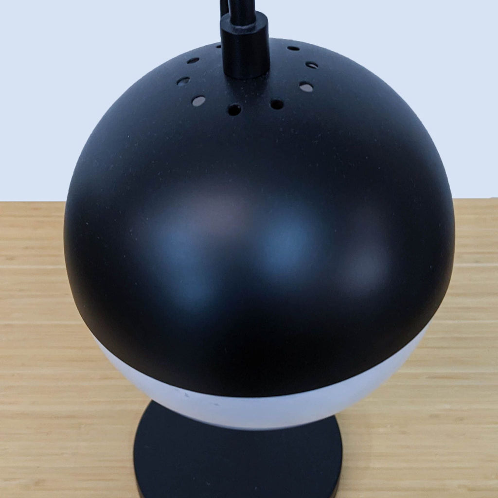 Top view of the Safavieh lamp focusing on the round, perforated shade.