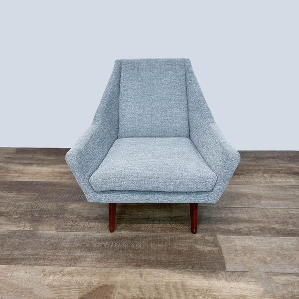 Front view of the Article Angle chair in tweed with wood legs.