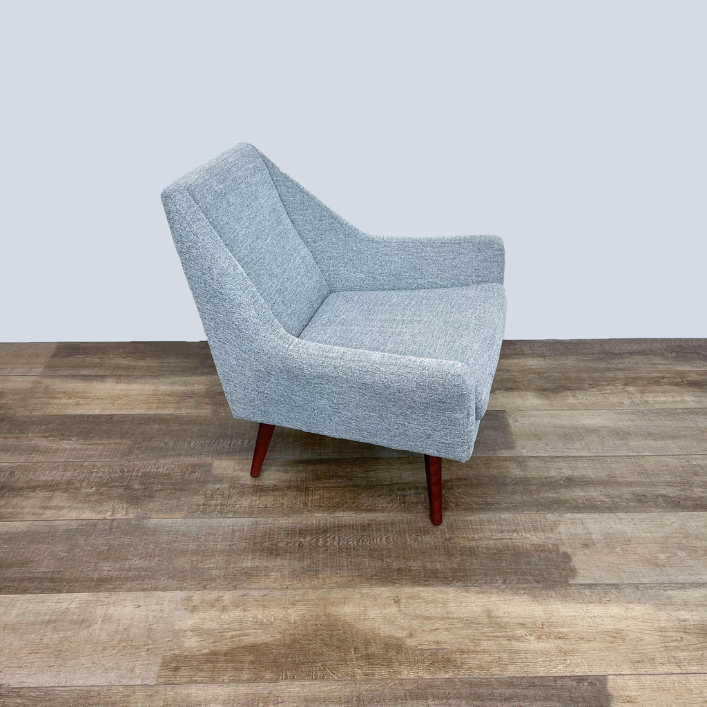 Side profile of the Angle chair by Article on wood floor.