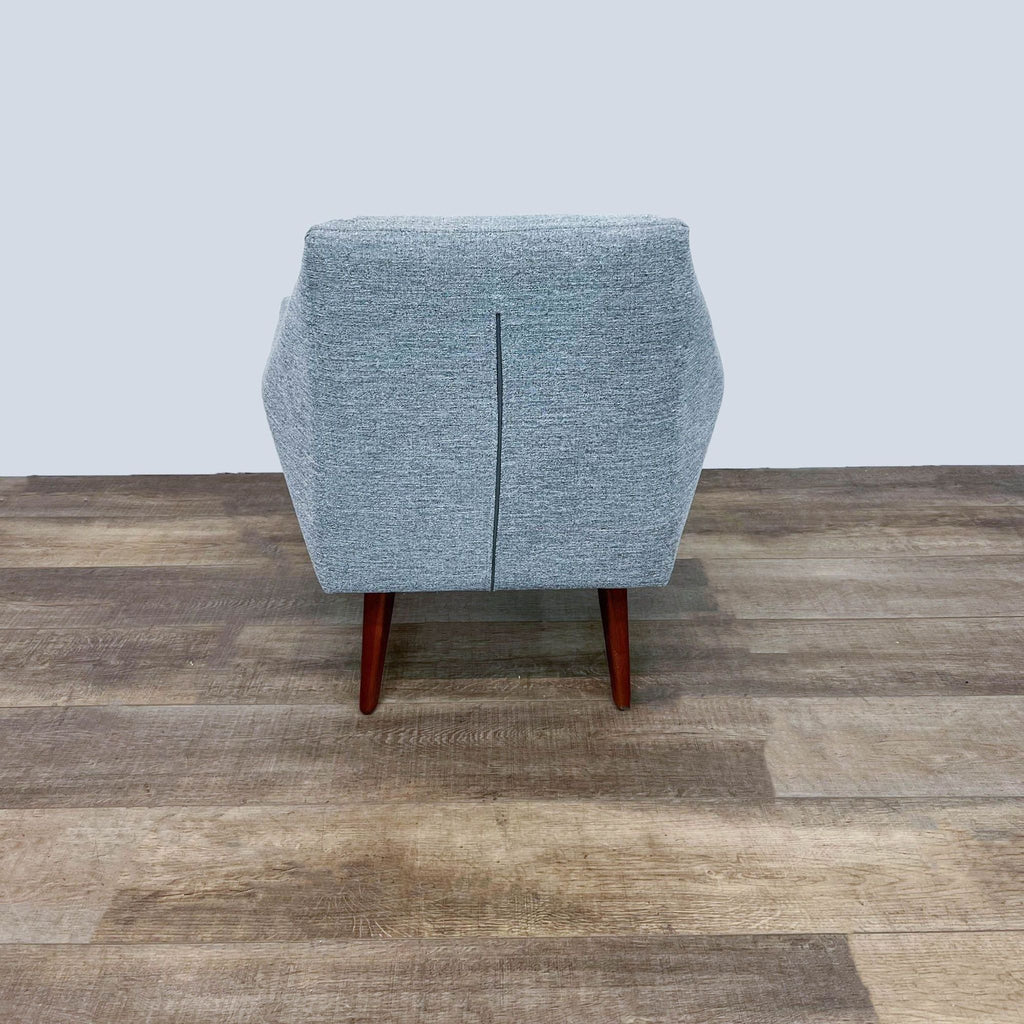 Back view of Angle chair showing tweed fabric and legs.
