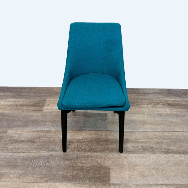 Front view of a modern teal dining chair with black legs.
