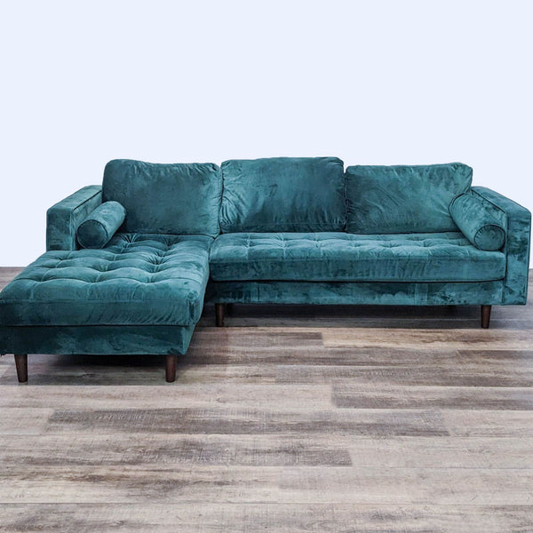 Green velvet tufted sectional with chaise, narrow arms, and tapered feet.