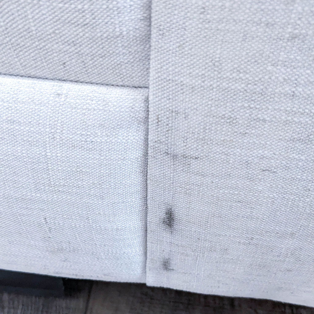 Close-up of sofa fabric and detailing, showing nailhead accents.